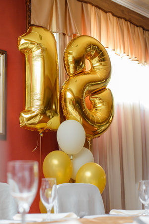 Balloons in the shape of the number eighteen of golden color as decorationの写真素材