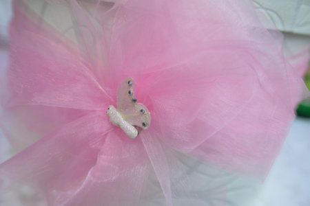 A white round box with a pink satin bow and a white dove for inserting greeting cardsの写真素材