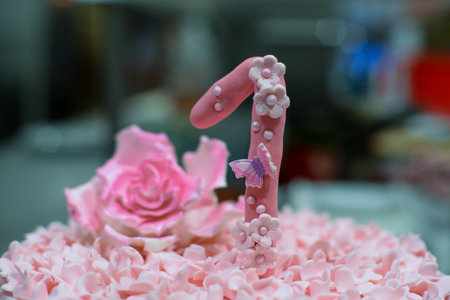 Birthday cake with pink candle and rose, shallow depth of fieldの写真素材