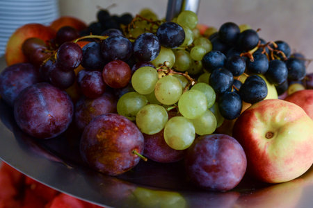 Fruit served for serving, watermelon, black and white grapes, plums, peaches.の写真素材