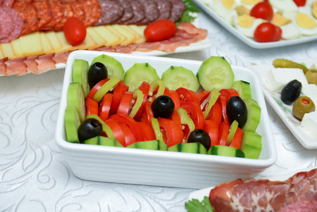 Salad of tomatoes, cucumbers, green peppers and a few pieces of olivesの写真素材
