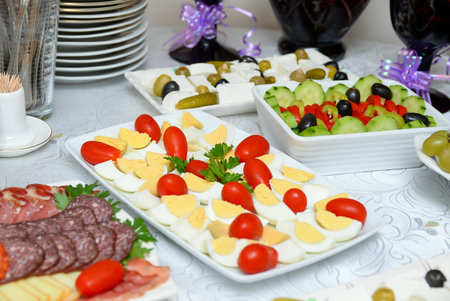 Salad of boiled eggs, cherry tomatoes decorated with parsley on the table.の写真素材