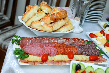 Salty rolls with a finely chopped dried meat appetizer in front of themの写真素材