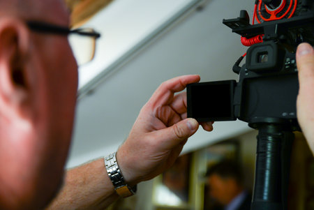 A cameraman uses a dslr or mirrorless camera to make the best possible video. in the frame is the screen of the deviceの写真素材