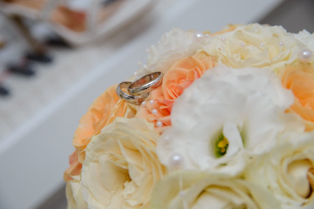 Wedding rings on a biedermeier of pastel flowersの写真素材