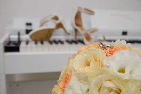White gold wedding rings on a biedermeier of pastel flowersの写真素材