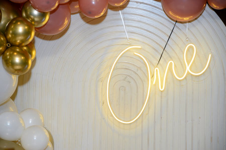 White background with various colorful balloons, neon number one, and neon letters that say number...
