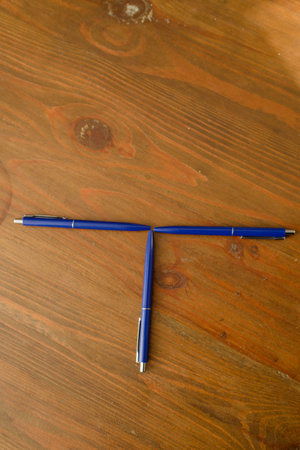 Ballpoint pens of blue color on a wooden base