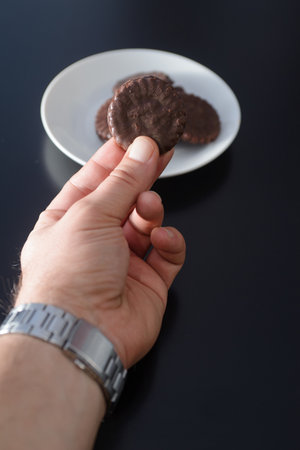 Biscuits covered with chocolate on both sides on a white plateの写真素材