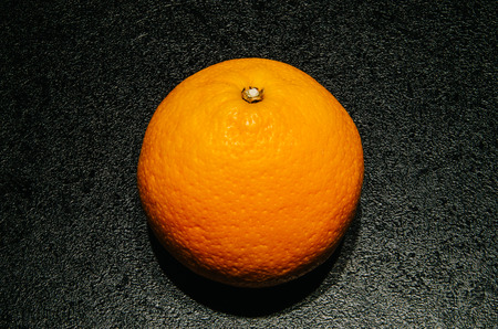 Orange on textured black backgroundの写真素材