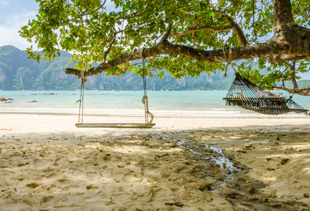 Swing set and hammock on the beach ocean viewの写真素材