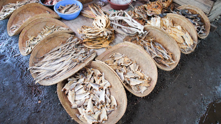 Dried fish in wooden baskets on asian market