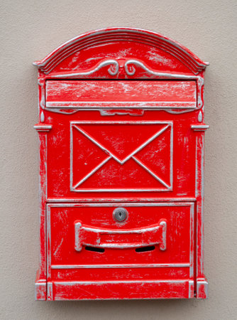 Antique red letter box or mail drop mounted on the wall. Close up. Detail. Background.の写真素材