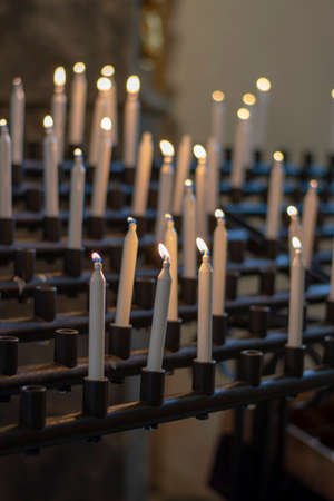 White candles burning in a church. Selective focus.の写真素材