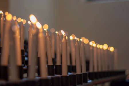 White candles burning in a church. Selective focus.の写真素材