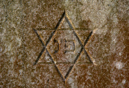 Jewish Star of David on the tombstone. Symbol of the Jews. Close up. Detail.