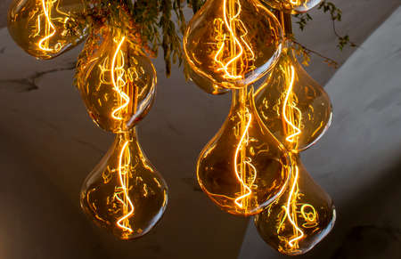 Decorative antique edison style filament light bulbs hanging from the ceiling.の写真素材