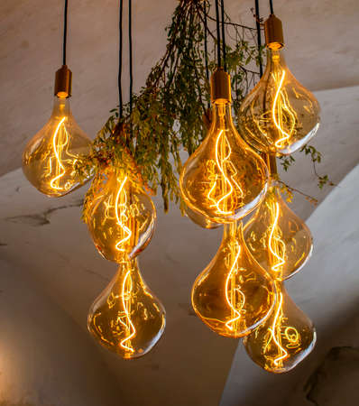 Decorative antique edison style filament light bulbs hanging from the ceiling.の写真素材