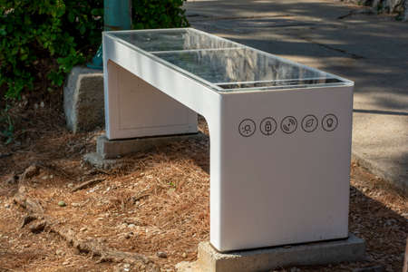 Moscenicka Draga, Croatia, august, 12, 2021 - Steora solar smart bench near the beach. Smart bench provides temperature and weather sensors, with wireless and wired charging for users.のeditorial素材