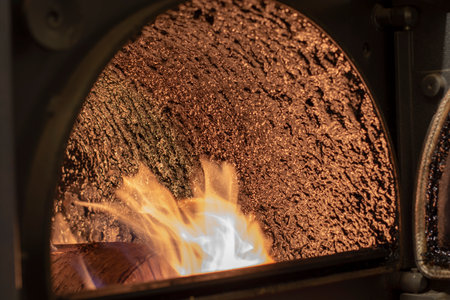 Tar deposit inside the wood fuel boiler. Shinny black deposit inside the solid fuel boiler. Creosote deposit.の写真素材