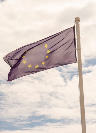 EU Flag waving in the wind against cloudy sky. Fluttering European Union flag.の写真素材