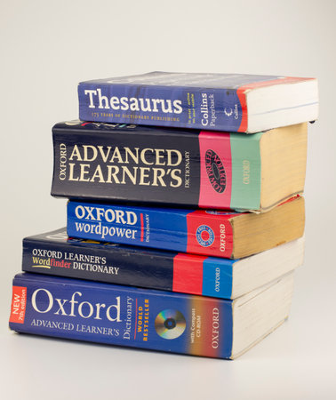 Nova Bana, Slovakia - April, 14, 2023 : A pile of english dictionaries isolated on white background.