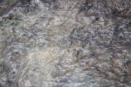 You can see the surface of a rock that looks uneven and grayの写真素材