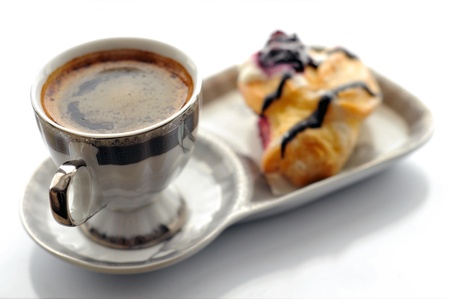 cup of coffee and cake on a white backgroundの写真素材