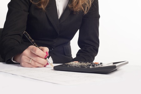 Business woman writing on a document