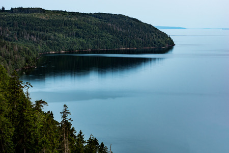 View over bay in lake vtter with surrounding forest, seen from Omberg Swedenの写真素材