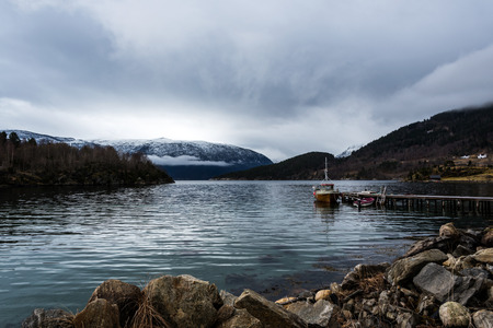 Small fishing boat in Norwegian fjordの写真素材