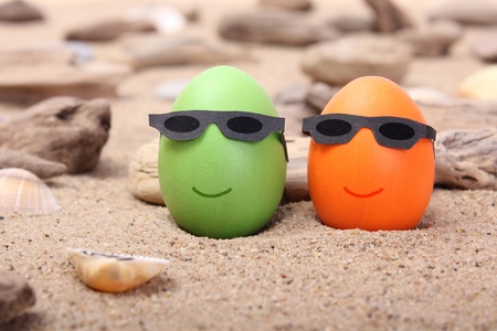 orange and green Easter egg on the beach