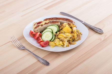 German sausage with baked potatoesの写真素材