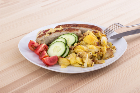 German sausage with baked potatoesの写真素材