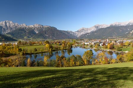 Panoramic view of Lake Ritzensee and Saalfelden on a sunny autumn day in with the mountains Steinernes Meer in the background. Saalfelden, Pinzgau, Salzburg Land, Austria.の写真素材