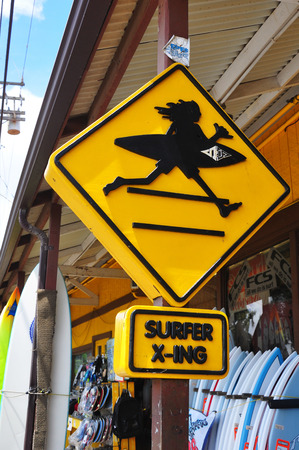 North Shore, Honolulu, Oahu/Hawaii, June 9, 2011: Surfer Crossing street sign in Haleiwa. Haleiwa is a popular destination for tourists for surfing and diving sites along the north shore on Oahu Island, Hawaii, United States.のeditorial素材