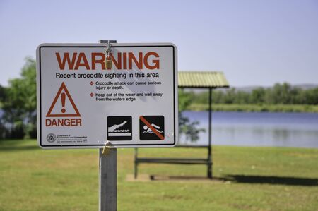Kununurra, Australia - November 9, 2010. Crocodile warning sign for recent crocodile sighting in this area. Picture taken near Kununurra, Western Australia, Australia.のeditorial素材