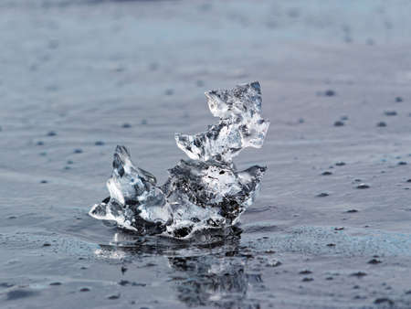 Melting ice on black sand