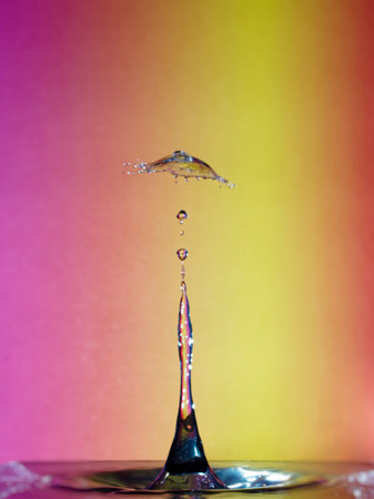 Falling drops of water. Splash effect after collision a falling drops with water surfaceの写真素材
