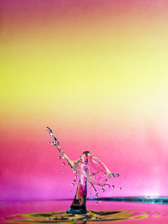 Falling drops of water. Splash effect after collision a falling drops with water surfaceの写真素材