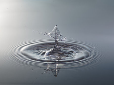 Water drop. Splash effect after collision a falling drops with water surfaceの写真素材