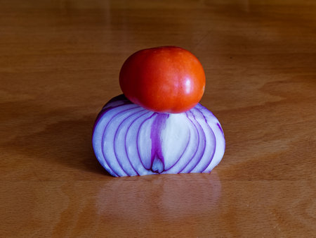 Tomato and onion on a wooden table. Close up.の写真素材
