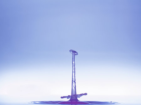 Falling drops of water. Splash effect after collision a falling drops with water surfaceの写真素材