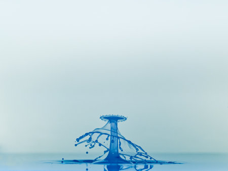Falling drops of water. Splash effect after collision a falling drops with water surfaceの写真素材