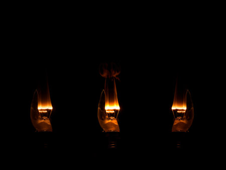 candle light on black background, incandescent lamp on black background