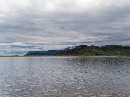 Scenic view of a lake with mountains and clouds in the backgroundの写真素材