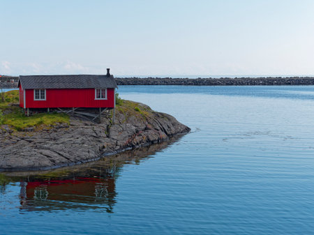 Red wooden house on a rocky island in Lofoten islands, Norway