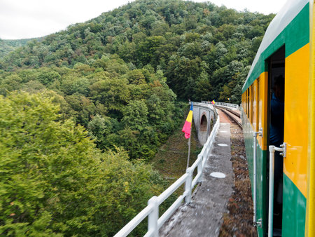 Passenger train on the railway in the mountains. View from above.の写真素材