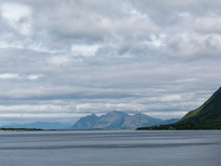 Norwegian fjord landscape with mountains and clouds in summer.の写真素材