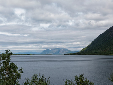 Norwegian fjord landscape in summer with mountains and clouds.の写真素材